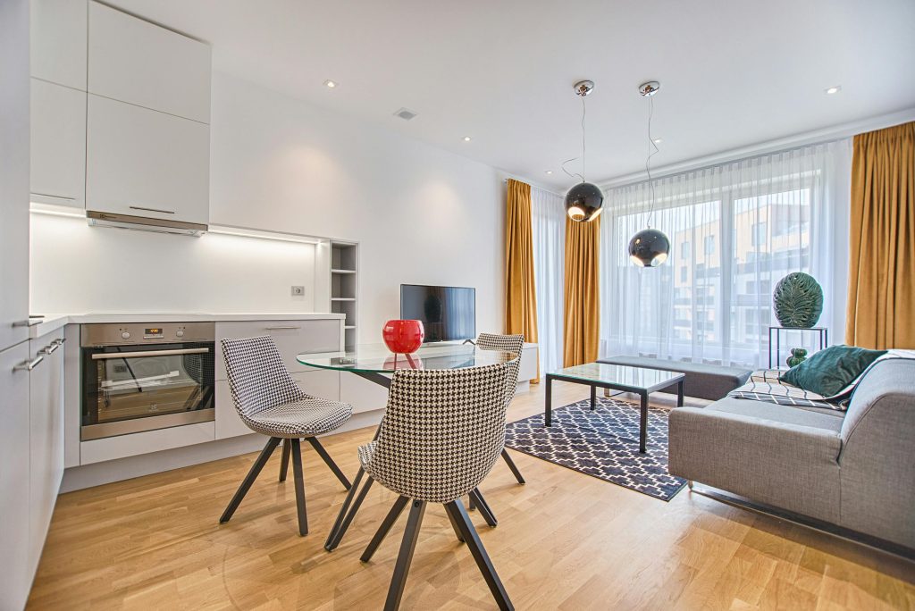 pexels-photo-1571453-1571453 Elegant Scandinavian-style living room and kitchen featuring modern furniture and decor.